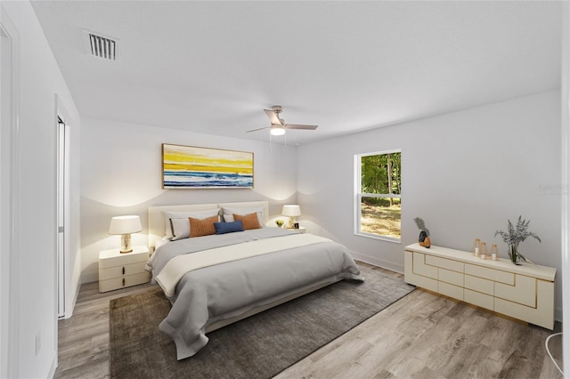 bedroom with ceiling fan and light hardwood / wood-style flooring