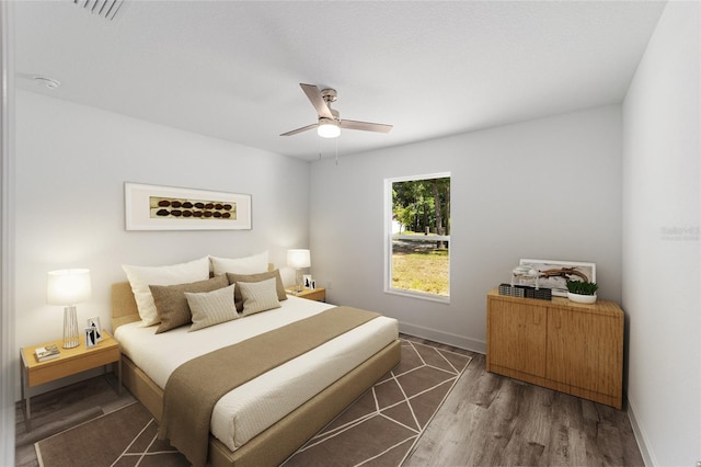 bedroom featuring ceiling fan and dark wood-type flooring