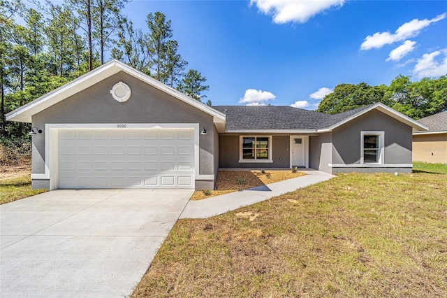 ranch-style home with a garage and a front yard