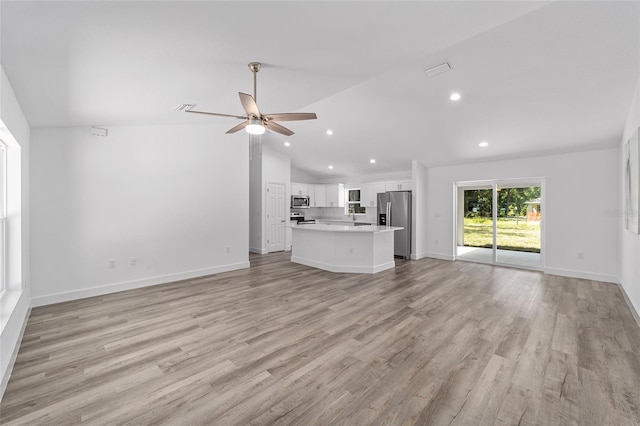 unfurnished living room with light hardwood / wood-style flooring, vaulted ceiling, and ceiling fan