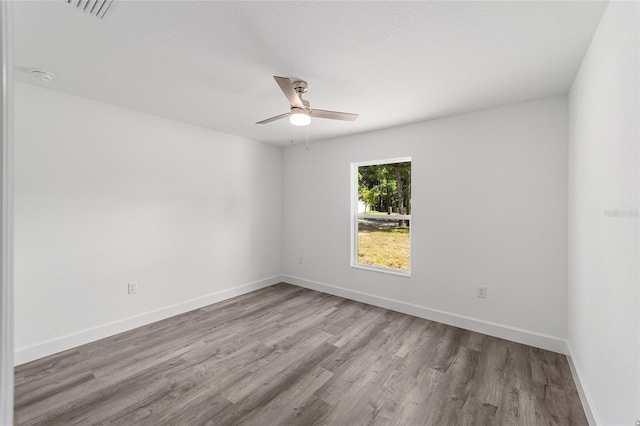 spare room featuring ceiling fan and light hardwood / wood-style floors