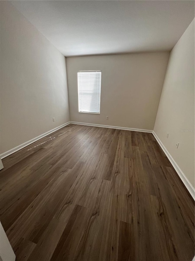 unfurnished room featuring dark hardwood / wood-style flooring