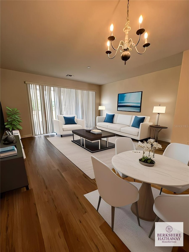 dining area with a notable chandelier and hardwood / wood-style floors