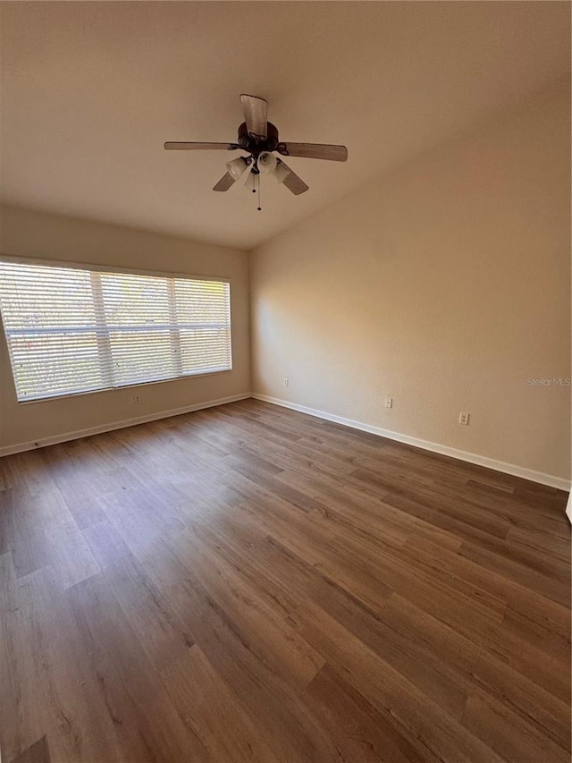 spare room with ceiling fan and dark hardwood / wood-style flooring