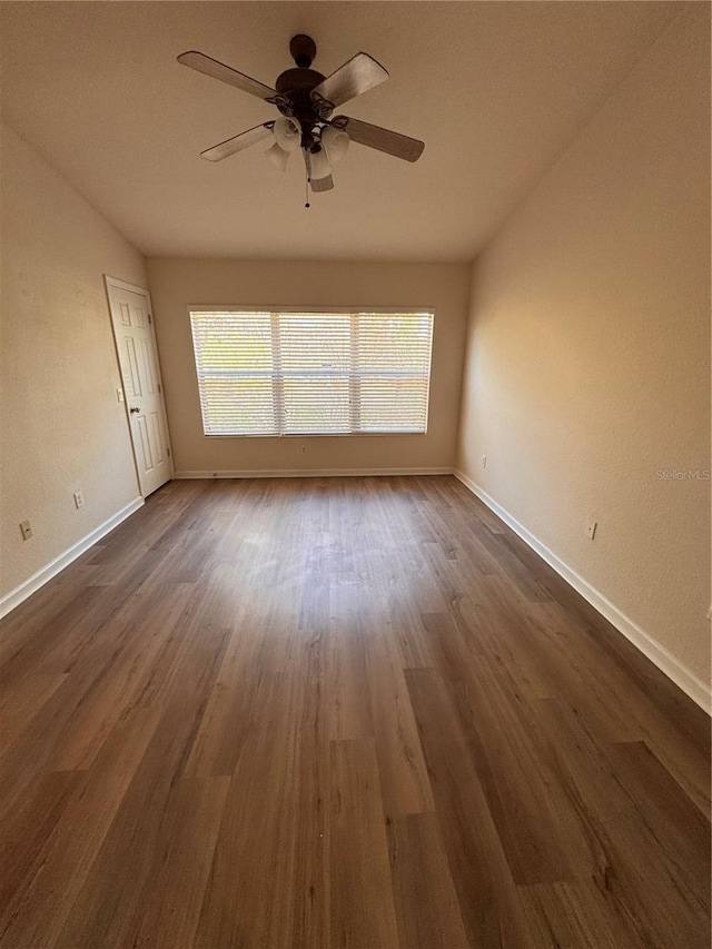 spare room featuring ceiling fan and dark hardwood / wood-style floors