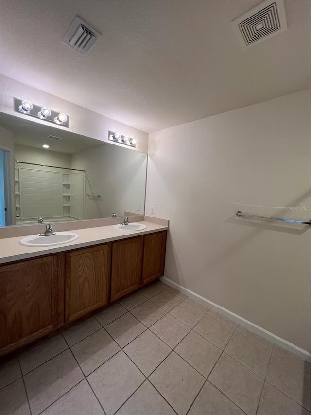 bathroom featuring tile patterned flooring and vanity