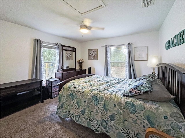 bedroom with multiple windows, ceiling fan, and carpet