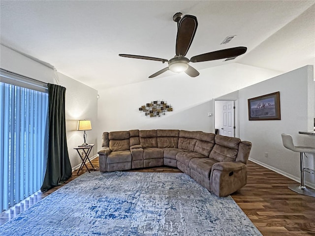 living room featuring dark hardwood / wood-style flooring, vaulted ceiling, and ceiling fan