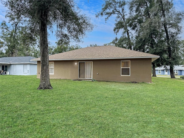 rear view of property with a yard