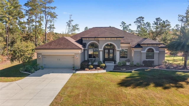 mediterranean / spanish-style house featuring a garage and a front lawn