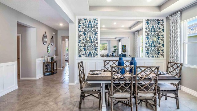 dining area with a tray ceiling