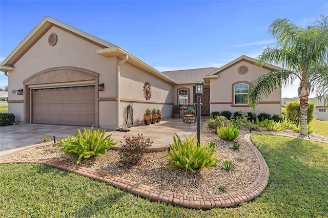 view of front of property with a front yard and a garage