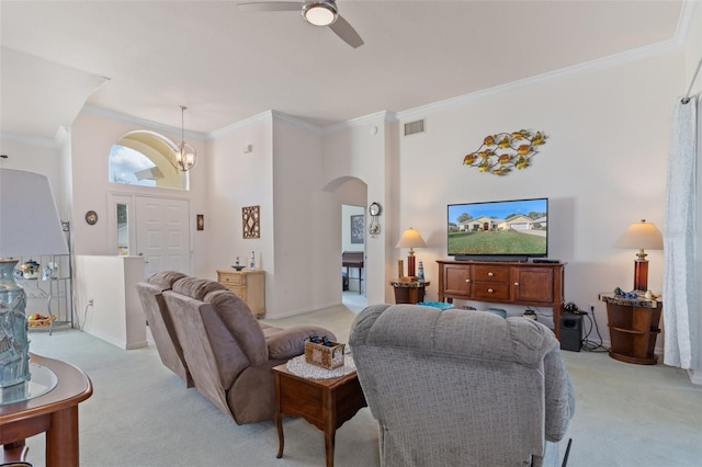 carpeted living room with ceiling fan with notable chandelier, a towering ceiling, and crown molding