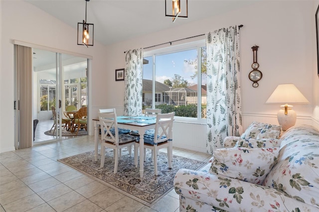 tiled dining space with vaulted ceiling