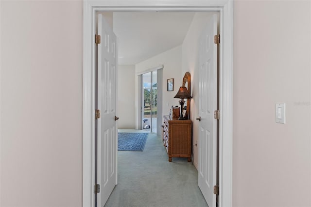 corridor featuring light colored carpet