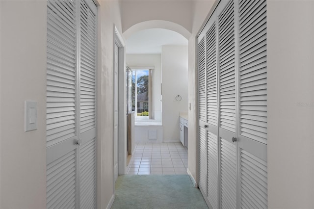 hallway featuring light colored carpet