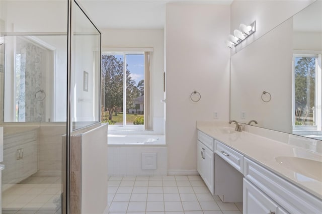 bathroom featuring tile patterned flooring, vanity, plenty of natural light, and independent shower and bath