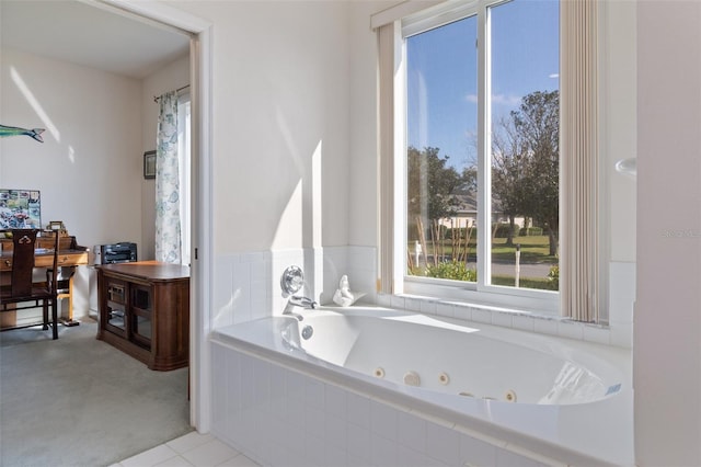 bathroom featuring tile patterned flooring and a relaxing tiled tub