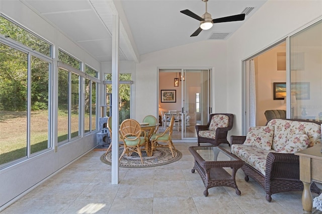 sunroom with ceiling fan and vaulted ceiling