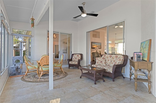 sunroom featuring vaulted ceiling and ceiling fan