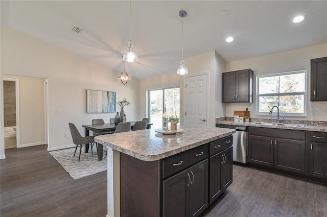 kitchen with sink, hanging light fixtures, vaulted ceiling, stainless steel dishwasher, and a kitchen island