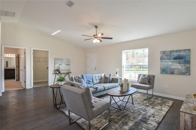 living room with dark hardwood / wood-style flooring, vaulted ceiling, and ceiling fan