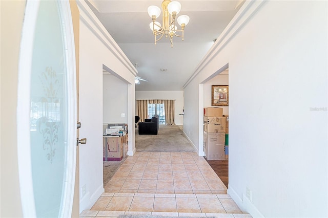 corridor with a chandelier and light tile patterned flooring