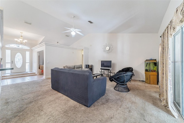 carpeted living room with ceiling fan with notable chandelier, a wealth of natural light, and lofted ceiling