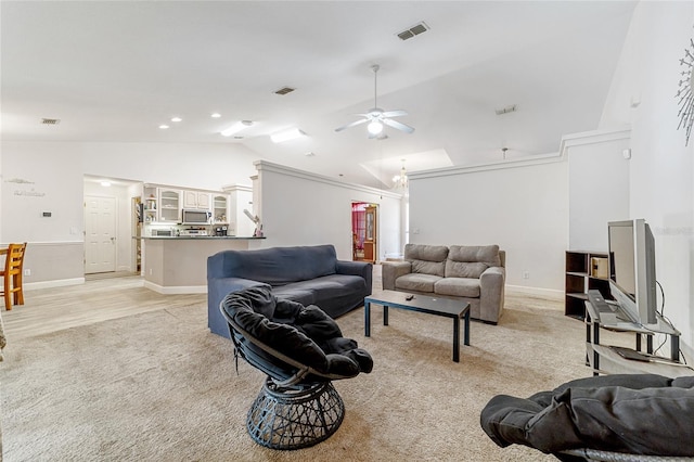 carpeted living room featuring ceiling fan and lofted ceiling