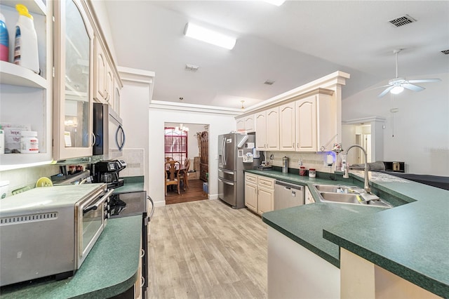 kitchen featuring ceiling fan, sink, stainless steel appliances, kitchen peninsula, and light hardwood / wood-style floors