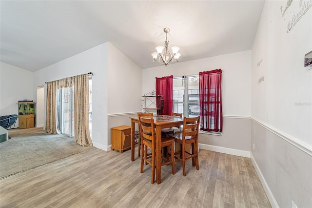 dining area with a wealth of natural light, a chandelier, and light hardwood / wood-style floors