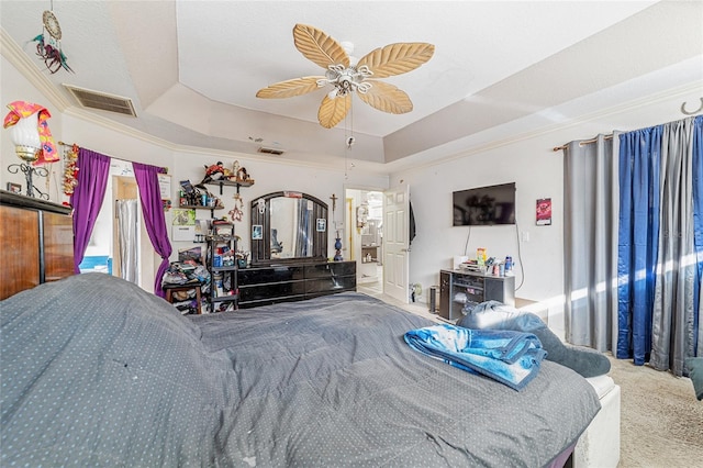 bedroom with carpet, a raised ceiling, ceiling fan, and crown molding