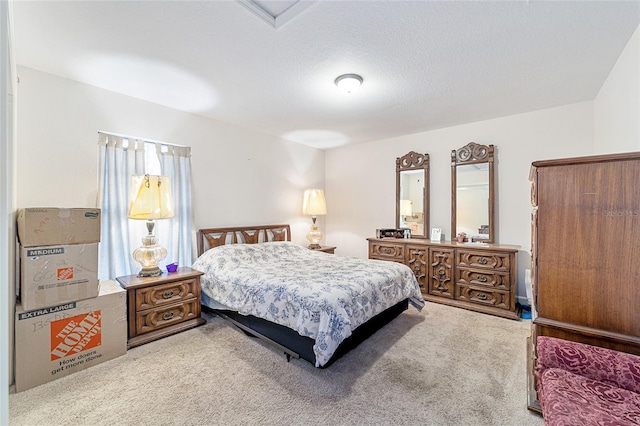 bedroom featuring carpet and a textured ceiling