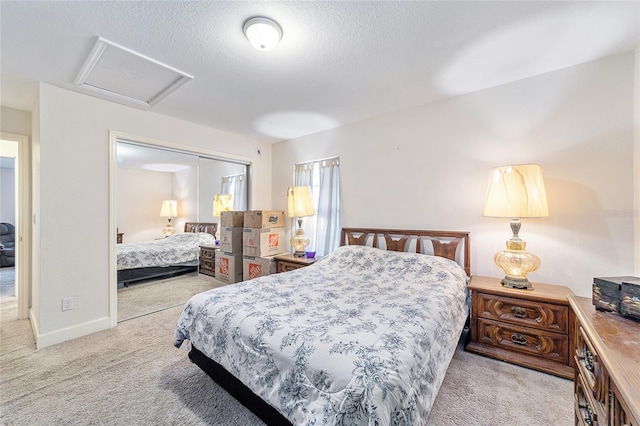 carpeted bedroom with a textured ceiling and a closet