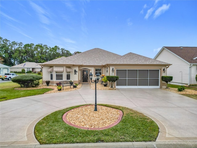 view of front of home featuring a garage and a front lawn