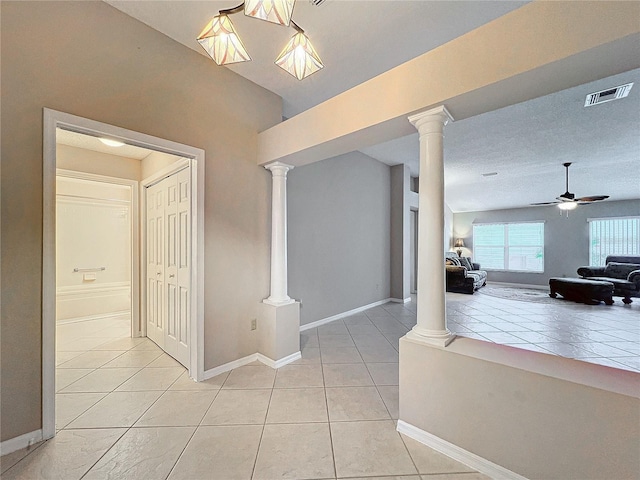 interior space with a textured ceiling and light tile patterned flooring