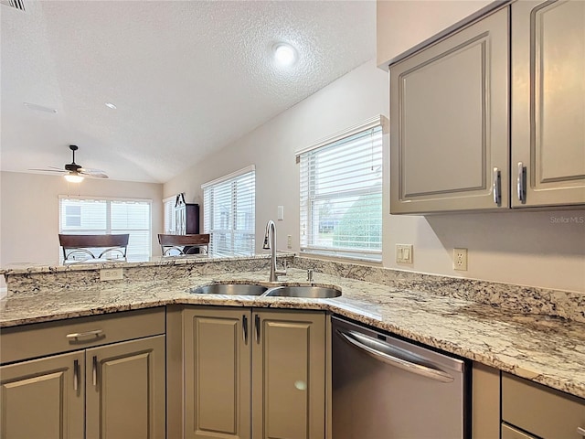 kitchen with a textured ceiling, vaulted ceiling, ceiling fan, sink, and dishwasher