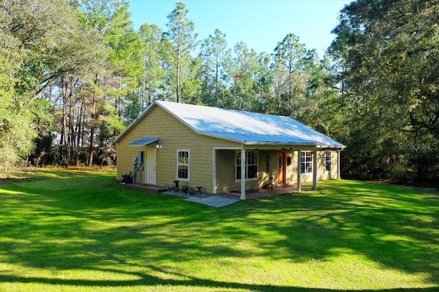 rear view of house featuring a lawn