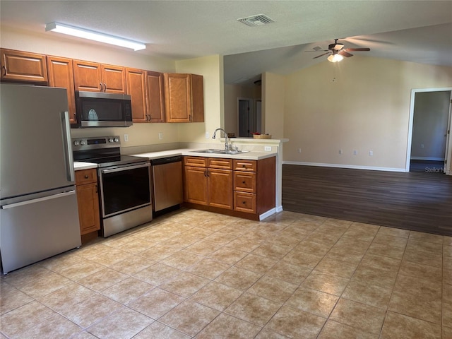 kitchen featuring sink, ceiling fan, light tile patterned floors, kitchen peninsula, and stainless steel appliances