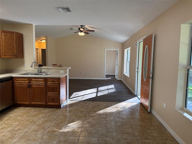 kitchen featuring ceiling fan, sink, stainless steel dishwasher, white refrigerator, and vaulted ceiling