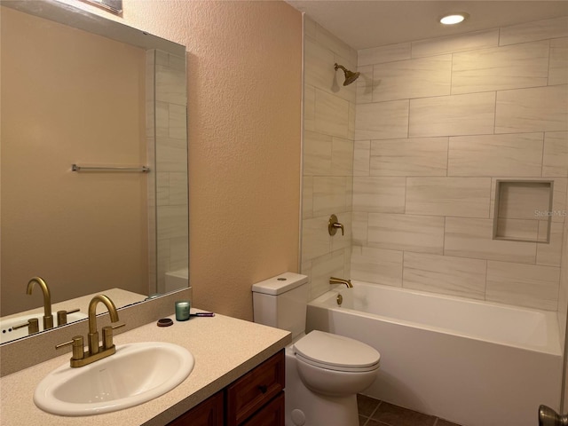 full bathroom featuring tile patterned flooring, tiled shower / bath combo, toilet, and vanity