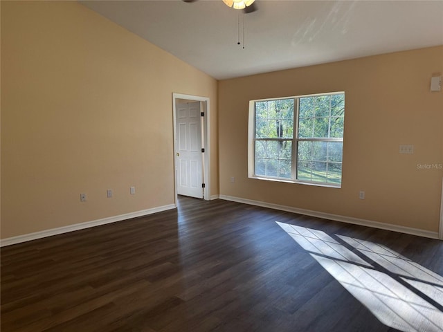 empty room featuring ceiling fan, lofted ceiling, and dark wood-type flooring