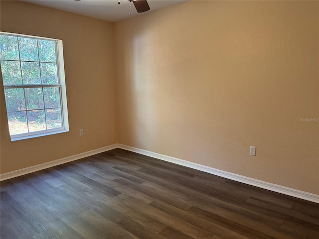 unfurnished room with ceiling fan, dark wood-type flooring, and a healthy amount of sunlight