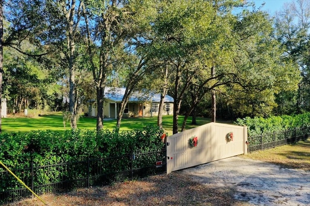 view of gate featuring a yard