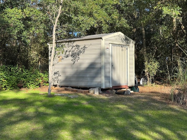 view of outbuilding with a yard