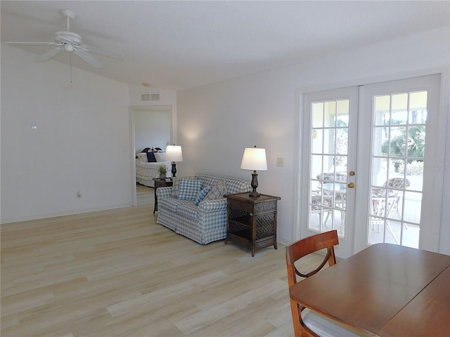 sitting room with ceiling fan, light hardwood / wood-style floors, and french doors