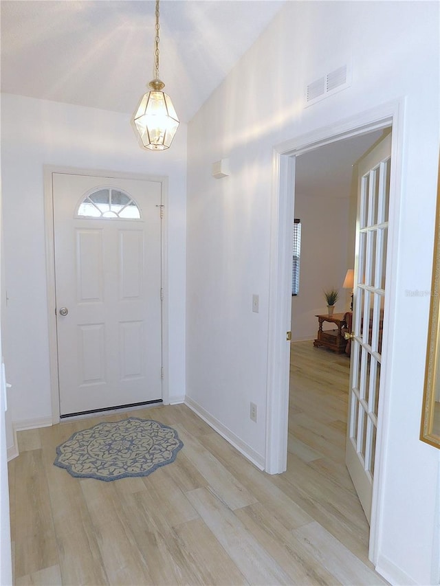 foyer entrance with light hardwood / wood-style flooring