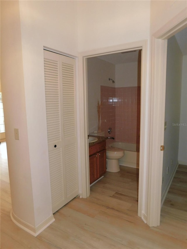 hallway with light hardwood / wood-style flooring