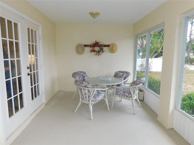 sunroom featuring french doors and a healthy amount of sunlight