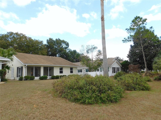 rear view of property featuring a yard